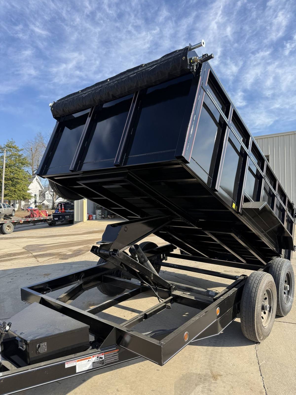 Triple R dump trailer with the bed fully raised mid dump