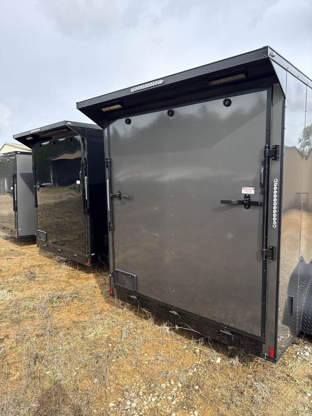 Rear doors of a charcoal Triple R enclosed cargo trailer with Black Out trim
