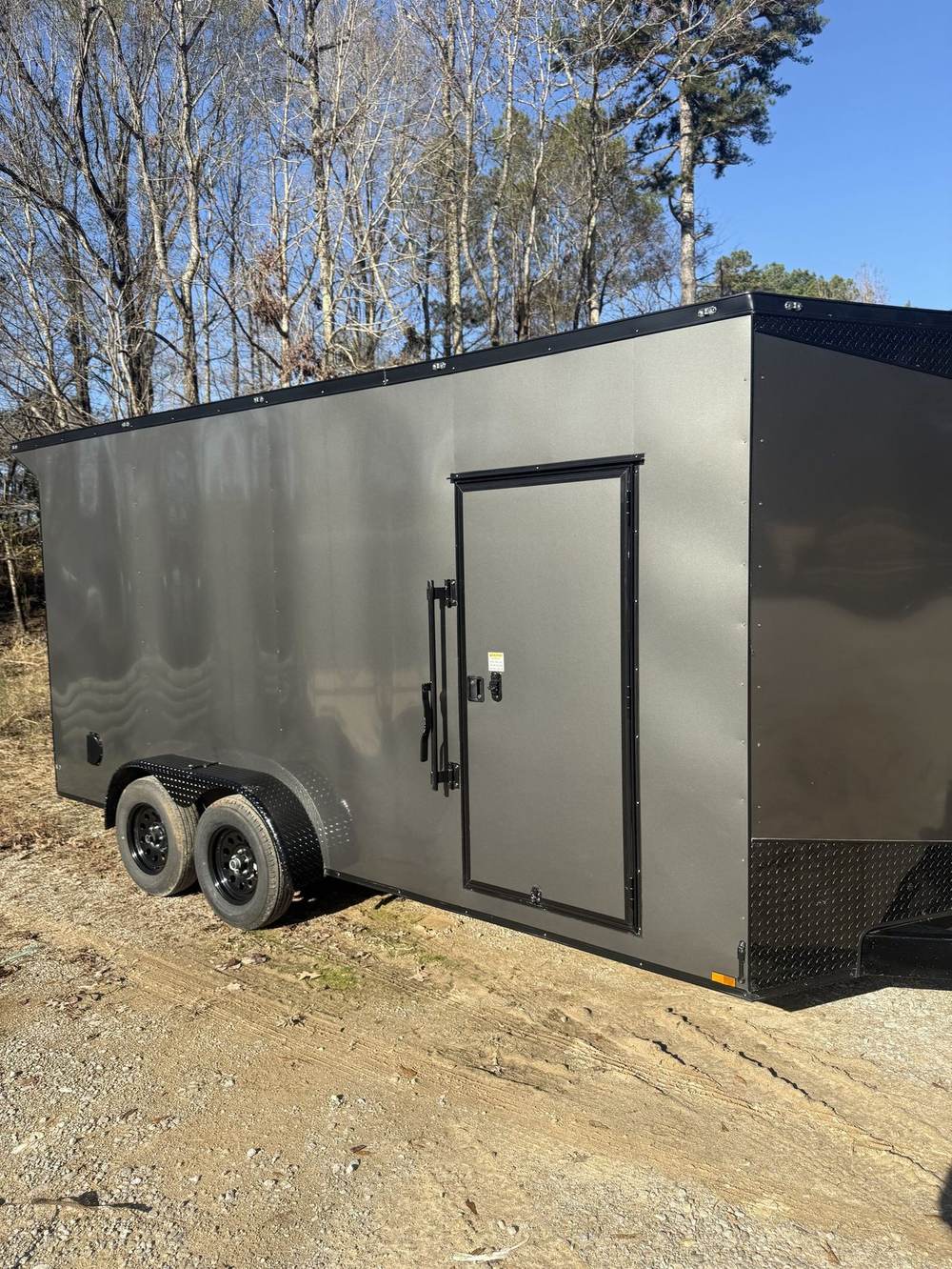 Gray Triple R enclosed cargo trailer with side door