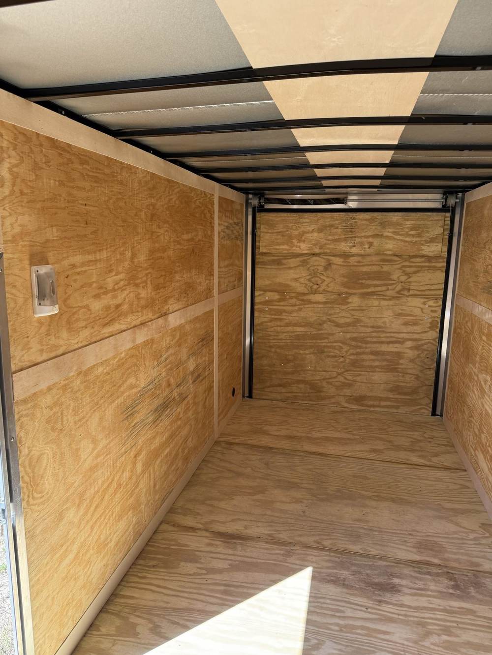 Plywood lined interior of a Triple R enclosed cargo trailer