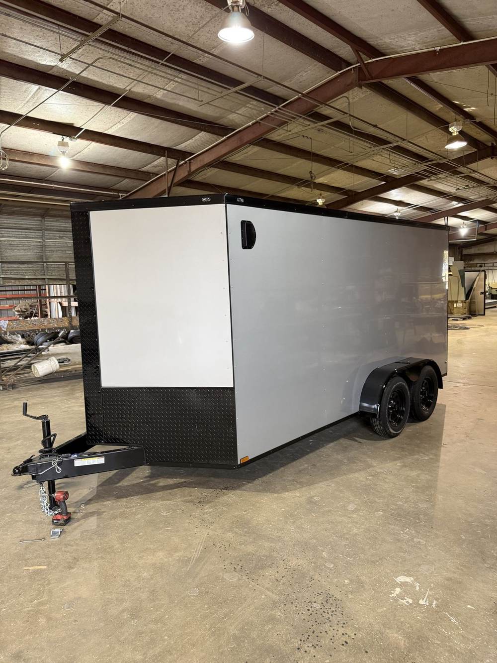 White enclosed trailer inside the Booneville shop