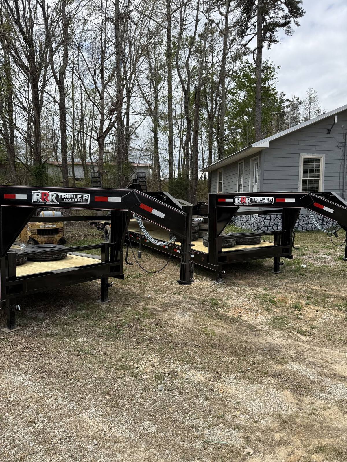 Triple R gooseneck deckover trailer with the RRR decal on the neck