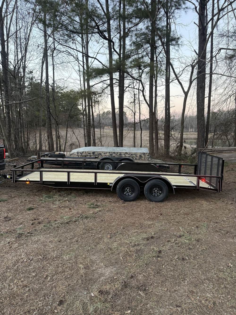Rear mesh gate on a Triple R utility trailer at sunset