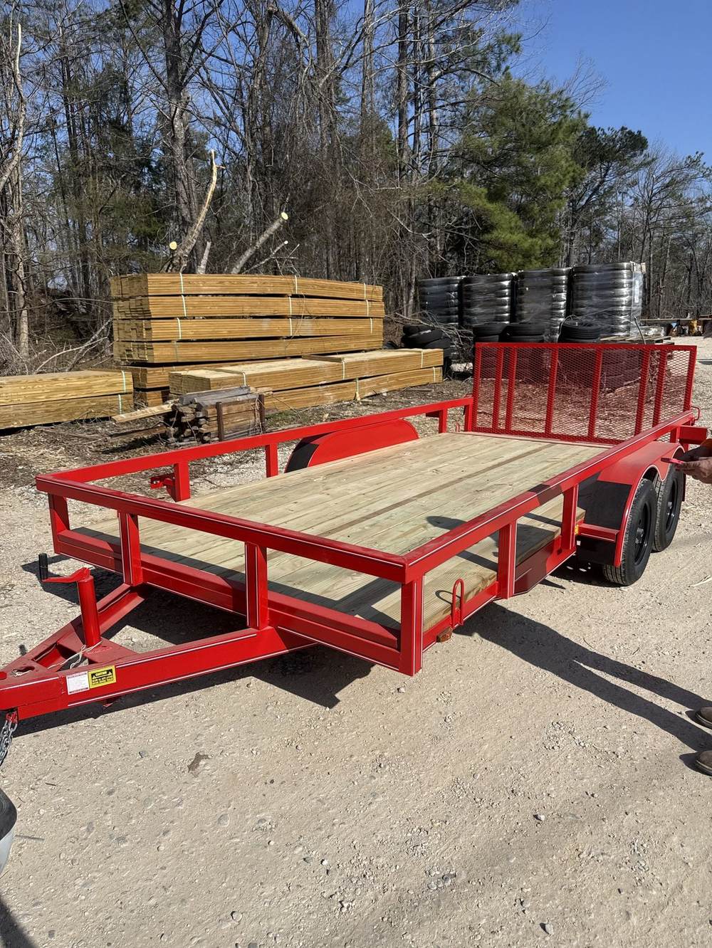 Red Triple R utility trailer with treated wood deck