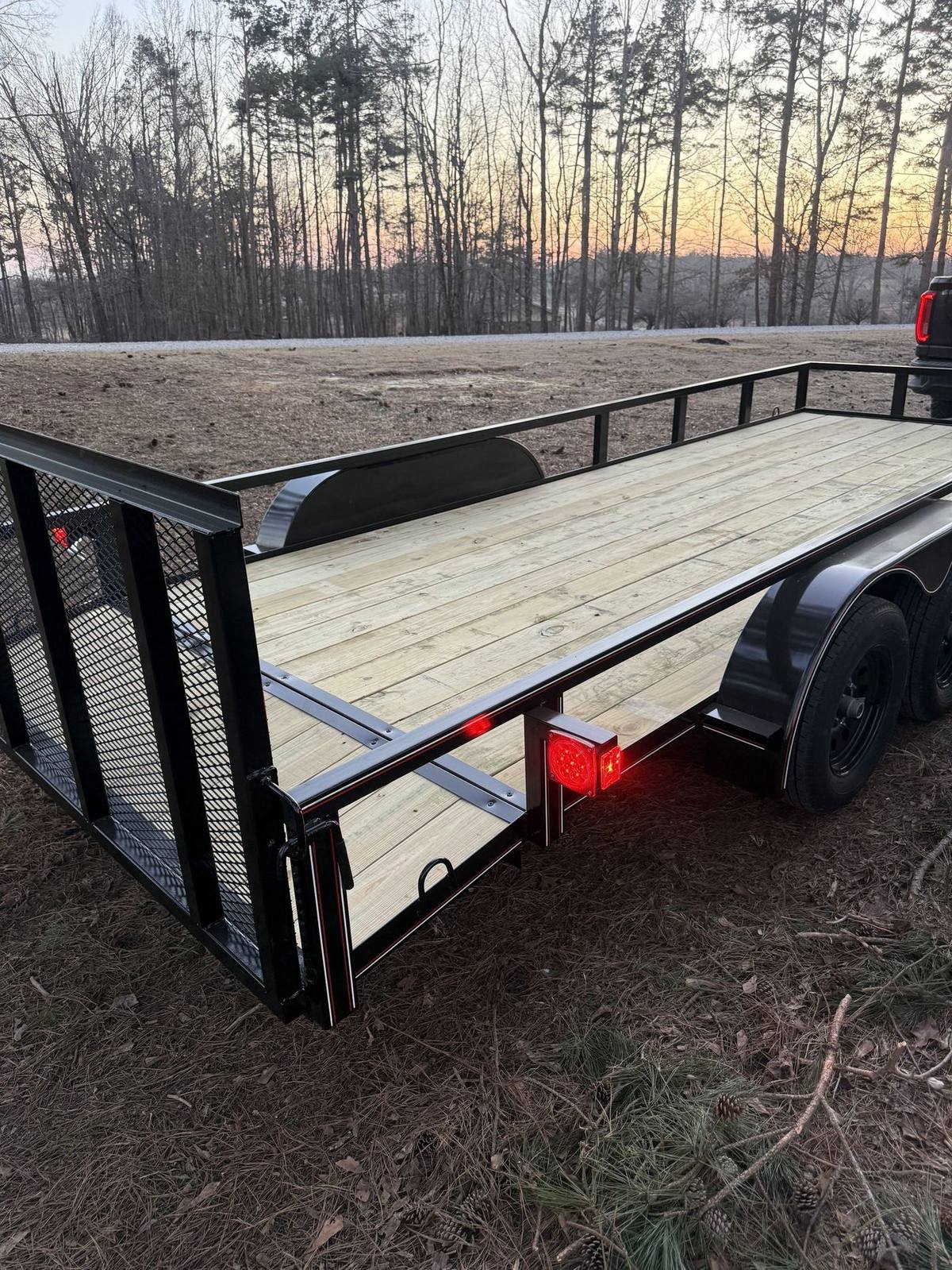 New Triple R wood deck utility trailer at sunset